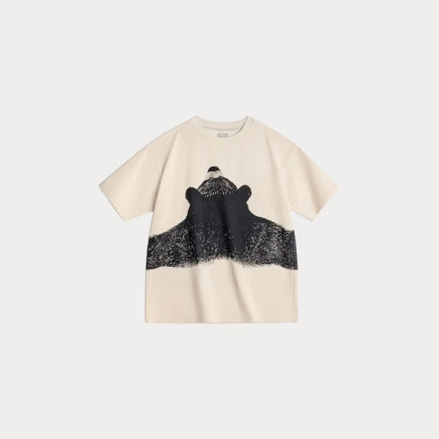 Beige t-shirt with a black and white graphic design on a light gray background